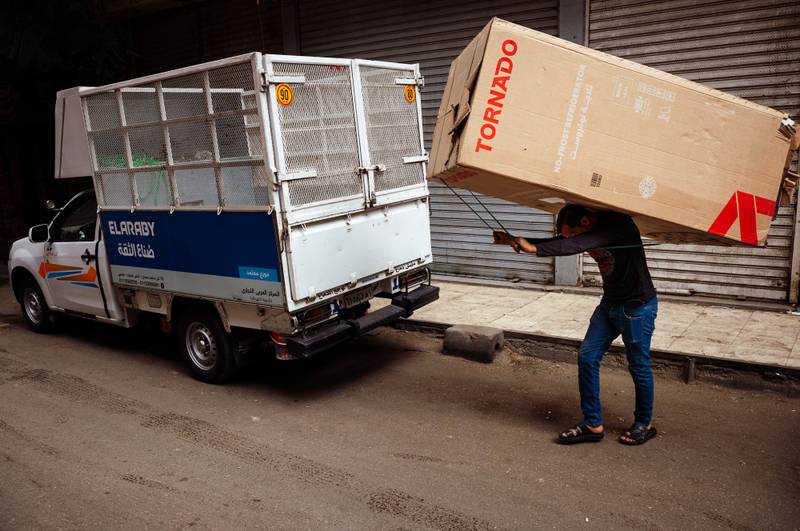 Man carrying a fridge